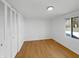 Bright bedroom with hardwood floors, white walls, and a window that provides natural light at 2928 Sheffield Dr, Indianapolis, IN 46229