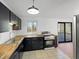 Modern kitchen with stainless steel appliances, dark cabinets, and butcher block countertops at 2928 Sheffield Dr, Indianapolis, IN 46229