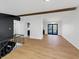 Bright open-concept living space with hardwood floors, open staircase, and access to deck at 2928 Sheffield Dr, Indianapolis, IN 46229