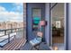Relaxing balcony with wood-look flooring, seating, and views of the neighborhood at 355 E Ohio St # 221, Indianapolis, IN 46204