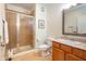 Bathroom with glass-enclosed shower, toilet, sink, and traditional vanity at 355 E Ohio St # 221, Indianapolis, IN 46204
