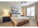 Bedroom featuring a comfy bed, side tables, lamps, and a sun-filled window at 355 E Ohio St # 221, Indianapolis, IN 46204