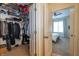 Walk-in closet provides ample storage with shelving and hanging space with bedroom access at 355 E Ohio St # 221, Indianapolis, IN 46204
