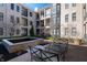 Apartment courtyard with water feature, wrought iron seating, and views of the surrounding building at 355 E Ohio St # 221, Indianapolis, IN 46204