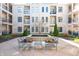 Courtyard featuring a fountain, seating area, and views of the surrounding building at 355 E Ohio St # 221, Indianapolis, IN 46204