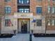 Entrance to a building with stone facade, flags, flower boxes and glass doors at 355 E Ohio St # 221, Indianapolis, IN 46204