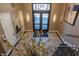 Hallway with doors, modern art, lighting fixtures, and decorative plants at 355 E Ohio St # 221, Indianapolis, IN 46204