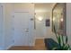 Apartment hallway with hardwood flooring, a modern mirror, and a decorative bench at 355 E Ohio St # 221, Indianapolis, IN 46204
