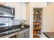 Kitchen featuring stainless steel appliances, grey cabinets, and a pantry at 355 E Ohio St # 221, Indianapolis, IN 46204