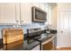 Close-up of modern kitchen appliances and black granite countertops at 355 E Ohio St # 221, Indianapolis, IN 46204