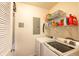 Functional laundry room with washer, dryer, shelving, and essential utility connections at 355 E Ohio St # 221, Indianapolis, IN 46204
