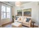 Bright living room features neutral decor, large window, and tasteful equestrian art at 355 E Ohio St # 221, Indianapolis, IN 46204