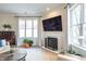 Cozy living area with a modern fireplace, and abundant natural light from surrounding windows at 355 E Ohio St # 221, Indianapolis, IN 46204