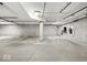 Unfinished parking garage level showing the raw construction and numbered parking spaces for tenants at 355 E Ohio St # 221, Indianapolis, IN 46204