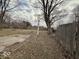 Overcast view of the backyard space with a wooden fence and some leaves at 3812 S Ebright St, Muncie, IN 47302