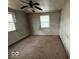 A simple bedroom with two windows and carpeted floor at 3812 S Ebright St, Muncie, IN 47302