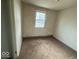 Compact bedroom with carpet and a view from the window to outside at 3812 S Ebright St, Muncie, IN 47302