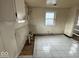 Image of a room with peeling paint and tile flooring at 3812 S Ebright St, Muncie, IN 47302