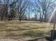 A large, grassy backyard is surrounded by mature trees and ready for entertaining at 3817 N Sheridan Ave, Indianapolis, IN 46226