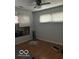 Sun-filled bedroom with ceiling fan, hard wood floors, and large windows with blinds at 3817 N Sheridan Ave, Indianapolis, IN 46226