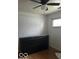 Bedroom with hardwood floors, ceiling fan, and white-covered window at 3817 N Sheridan Ave, Indianapolis, IN 46226