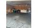 A large empty garage with a cracked concrete floor offers lots of storage space at 3817 N Sheridan Ave, Indianapolis, IN 46226