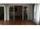 Spacious living room with wood floors and large entryway with unique doors at 3817 N Sheridan Ave, Indianapolis, IN 46226