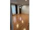 Living room featuring wood flooring, neutral walls, and an entrance to another room at 3817 N Sheridan Ave, Indianapolis, IN 46226