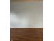 Neutral-toned wall with wood trim and outlets above wood-look flooring at 3817 N Sheridan Ave, Indianapolis, IN 46226