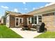 A backyard patio features an outdoor dining set and a grill perfect for entertaining in a bricked exterior at 3941 Stratfield Way, Westfield, IN 46074