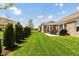 View of a well-manicured backyard with green grass and a patio area with outdoor furniture at 3941 Stratfield Way, Westfield, IN 46074