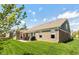 View of a brick home exterior with a manicured lawn and a patio area with outdoor furniture at 3941 Stratfield Way, Westfield, IN 46074