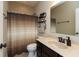 Bathroom with dark wood vanity, modern fixtures, and a shower with a neutral-toned shower curtain at 3941 Stratfield Way, Westfield, IN 46074