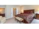 Spacious bedroom with a comfortable chair, bedside tables, and a decorative bench at the foot of the bed at 3941 Stratfield Way, Westfield, IN 46074