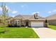 Charming brick home with a well-manicured lawn and attached two car garage at 3941 Stratfield Way, Westfield, IN 46074