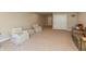 Comfortable living room with neutral carpet and walls, featuring stylish chairs and access to storage space at 3941 Stratfield Way, Westfield, IN 46074