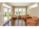 Bright sunroom featuring hardwood floors, multiple windows with wooden shutters, and access to outdoor space at 3941 Stratfield Way, Westfield, IN 46074