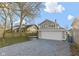 Backyard featuring detached garage, gravel driveway and lush lawn at 3960 N Park Ave, Indianapolis, IN 46205