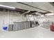 Unfinished basement featuring concrete floor, a stainless steel washer-dryer, and a utility sink at 3960 N Park Ave, Indianapolis, IN 46205