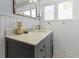 Bathroom featuring gray vanity with marble countertop, decorative gold pineapple, and a decorative mirror at 3960 N Park Ave, Indianapolis, IN 46205
