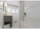 Bright bathroom with wainscoting, a gray vanity with marble countertop, and a shower-tub combination at 3960 N Park Ave, Indianapolis, IN 46205