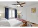 Bedroom with a ceiling fan, hardwood floors, and ample natural light from a large window at 3960 N Park Ave, Indianapolis, IN 46205