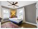 Cozy bedroom featuring wood floors, two large windows with lots of natural light, and a ceiling fan at 3960 N Park Ave, Indianapolis, IN 46205