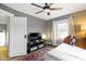 Comfortable bedroom featuring a ceiling fan, natural light from the window, and a TV on a shelf at 3960 N Park Ave, Indianapolis, IN 46205