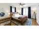 Bright bedroom featuring hardwood floors, a ceiling fan, and stylish curtains at 3960 N Park Ave, Indianapolis, IN 46205