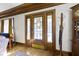 Elegant entryway with a wood door, detailed trim, and hardwood floors at 3960 N Park Ave, Indianapolis, IN 46205