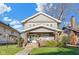 Charming two-story home featuring a welcoming front porch with brick pillars and lush landscaping at 3960 N Park Ave, Indianapolis, IN 46205