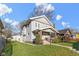 Two-story home with a well-maintained lawn and detached garage with white siding at 3960 N Park Ave, Indianapolis, IN 46205