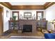 Cozy fireplace with brick surround and built-in shelving, flanked by stained-glass windows at 3960 N Park Ave, Indianapolis, IN 46205