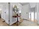 Hallway featuring a decorative table, two lamps, a rug, and white walls and trim at 3960 N Park Ave, Indianapolis, IN 46205